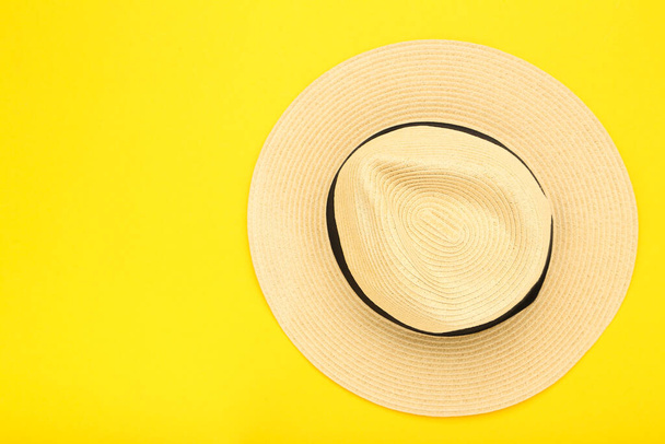Summer straw hat on yellow background - Fotó, kép