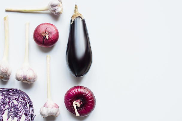 top view of red onion, red cabbage, eggplant and garlic on white background - Фото, изображение