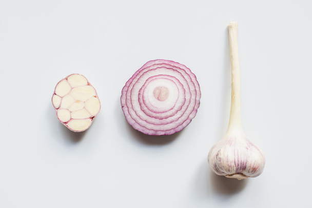 top view of cut red onion and garlic on white background - Фото, зображення
