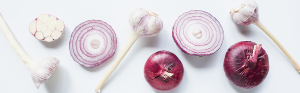 top view of cut and whole red onion and garlic on white background, panoramic shot - Fotografie, Obrázek