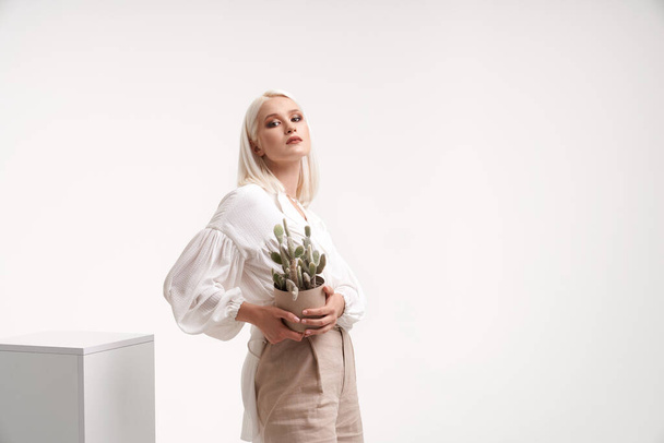 Portrait of female model posing with cactus. - Fotó, kép