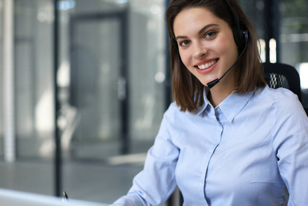 Portrait of happy smiling cheerful support phone operator in headset at office - Foto, Imagen