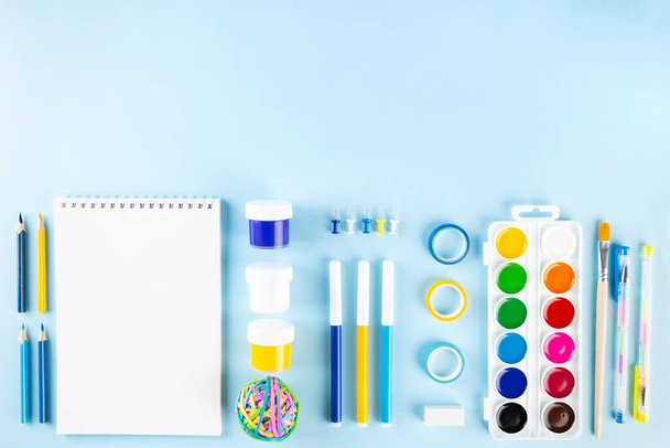 Various school office supplies on blue background. Back to school concept. Top view. Copy space - Fotoğraf, Görsel
