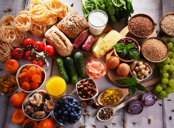 Skład z różnych ekologicznych produktów spożywczych na drewnianym stole kuchennym. - Zdjęcie, obraz