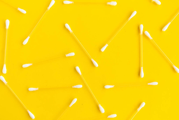 Cotton buds pattern on bright yellow background, top view - Foto, Imagem