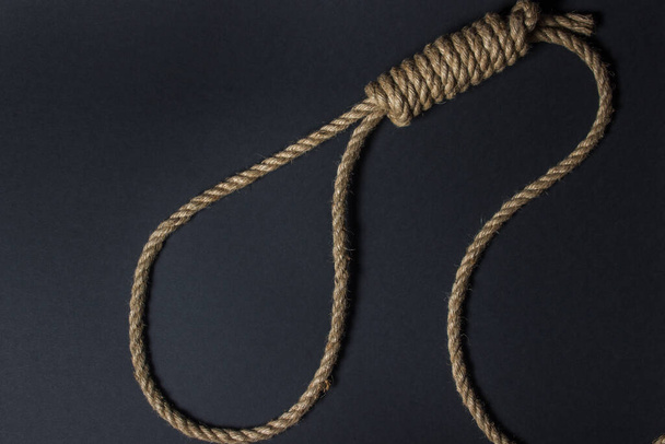 Loop from a rope on a black background. Social problem. The end of the path - Foto, Imagem