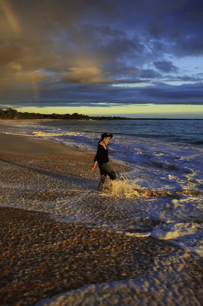 Woman walking on the shore alone - Photo, Image