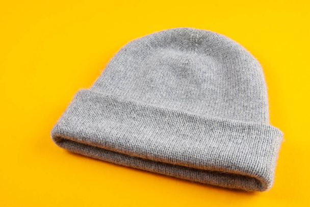 Knitted gray alpaca mink wool hat on yellow background - Foto, immagini