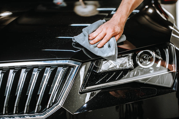 Professional detailing a car in car studio, hands with orbital polisher, scratching remover, vehicle care concept - Φωτογραφία, εικόνα