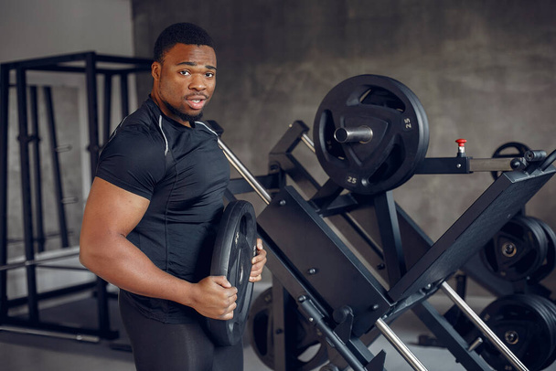 A handsome black man is engaged in a gym - Φωτογραφία, εικόνα
