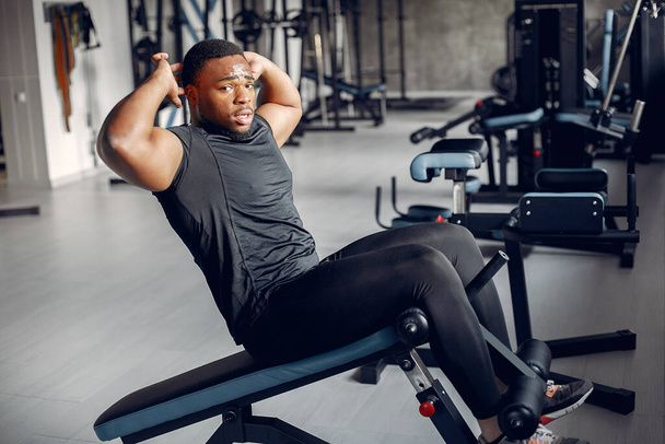A handsome black man is engaged in a gym - Fotografie, Obrázek