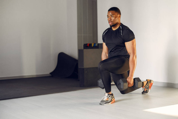 Un hombre negro guapo se dedica a un gimnasio - Foto, imagen