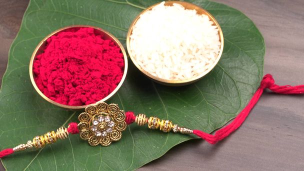 Raksha Bandhan festivali konsepti renkli arka planda ayrıntıları gösteren tasarımcı Rakhi veya bileklik bandını gösteriyor. Kardeşler ve Kız Kardeşler arasındaki aşkın sembolü. Seçici odak. - Fotoğraf, Görsel