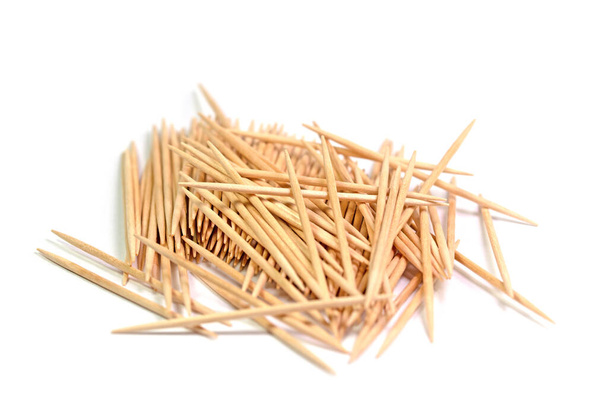 Wooden toothpicks against white background - Foto, afbeelding