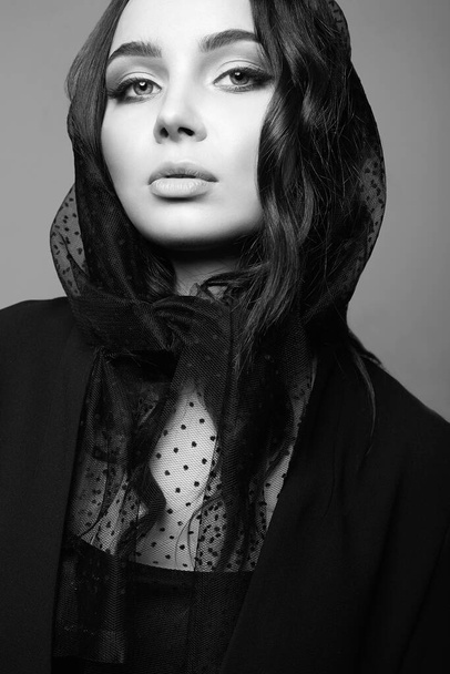 Beautiful young woman. Sorrow girl in veil. Black and white portrait - Fotó, kép