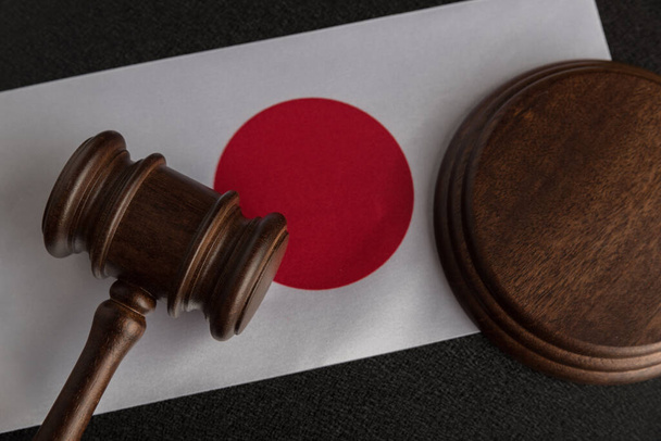 Juristen hölzern vor dem Hintergrund der Flagge Japans. Recht und Gerechtigkeit. Legalitätskonzept. - Foto, Bild