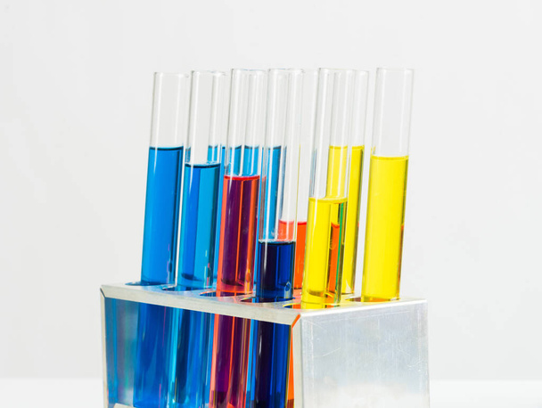Science laboratory research and development. Modern biochemistry industry mockup. Close up test tubes with color liquid on white background. Chemical manufacture concept with glass equipment. - Photo, image