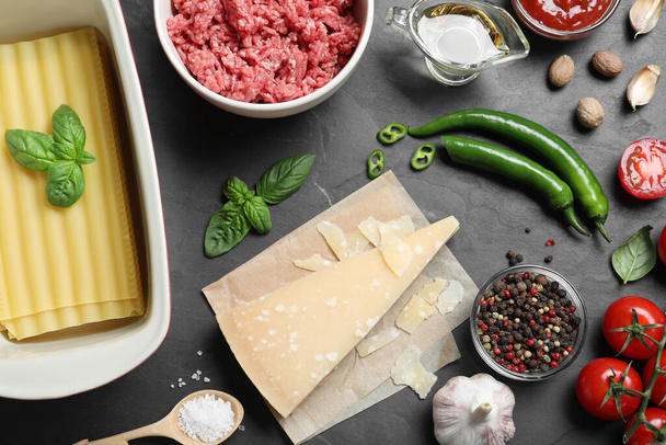 Fresh ingredients for lasagna on black table, flat lay - Photo, image