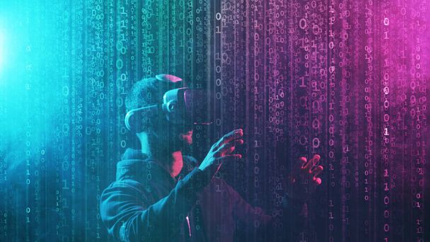 Portrait of a man in virtual reality helmet over abstract digital background. Obscured dark face in VR goggles. Internet, darknet, gaming and cyber simulation concept. - Photo, image