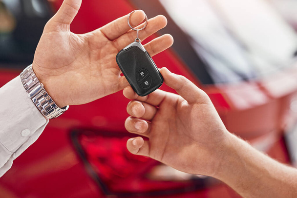 Manager giving car keys to client - Foto, imagen