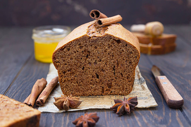 Gingerbread and honey loaf cake with cinnamon and anise on wooden background. Rustic style. - Zdjęcie, obraz