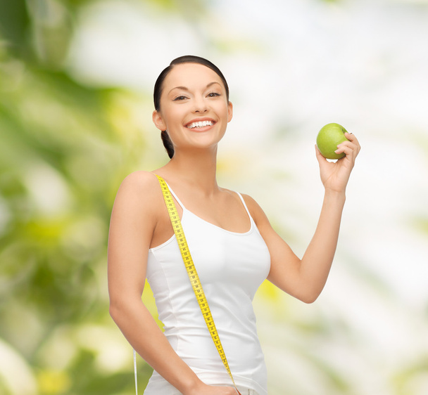 Sportliche Frau mit Apfel und Maßband - Foto, Bild