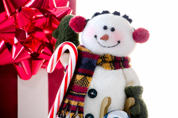 Snowman with candy cane on white - Photo, Image