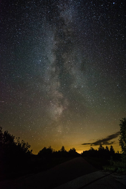 Bright milky way on a summer night through the clouds - Foto, Imagen