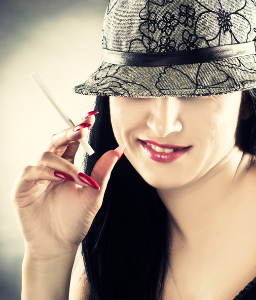 Beautiful smoking woman wearing hat - Фото, изображение