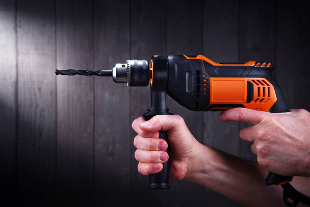 Male hands holding power drill.  - Фото, изображение