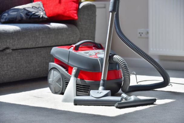 Canister vacuum cleaner for home use on the floor in the apartment. - Photo, Image