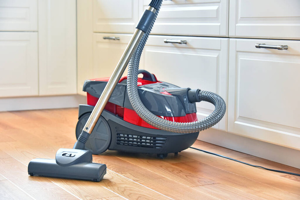 Canister vacuum cleaner for home use on the floor in the apartment. - Foto, Bild