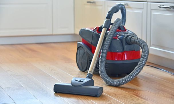 Canister vacuum cleaner for home use on the floor in the apartment. - Foto, Imagem