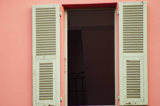 Window with white wooden shutters against a pink wall - Photo, Image