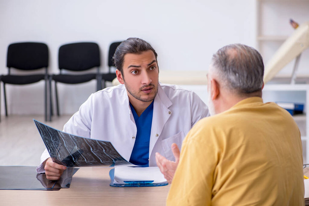 Old patient visiting young male doctor radiologist - Photo, Image