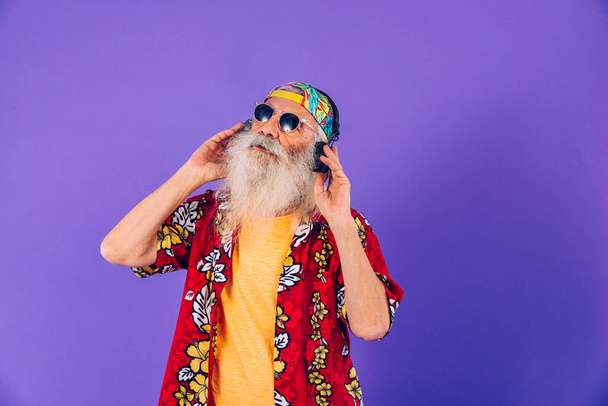Senior man with eccentric look  - 60 years old man having fun, portrait on colored background, concepts about youthful senior people and lifestyle - Photo, image