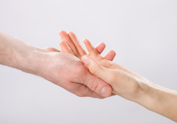 Man's hand gently holding woman's hand - Photo, Image