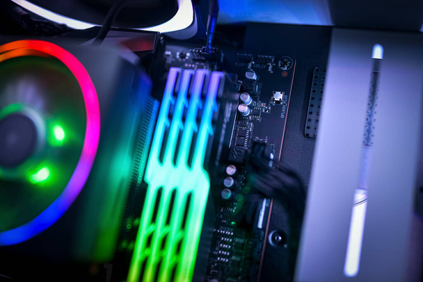 Close up of a computer motherboard, RGB memory and RGB CPU fan - Photo, image
