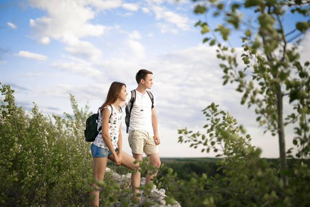Pretty couple enjoying time of each outdoors with beautiful view and bluse sky. CAMPING AND TOURISM CONCEPT. - Photo, Image