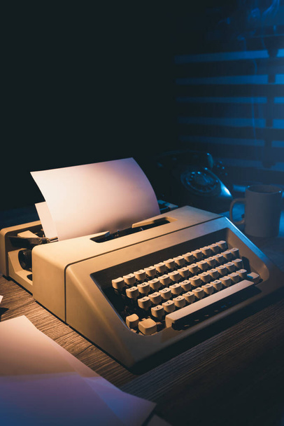 Old typewriter on a desk at night - Photo, image