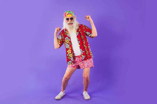 Senior man with eccentric look  - 60 years old man having fun, portrait on colored background, concepts about youthful senior people and lifestyle - Photo, image