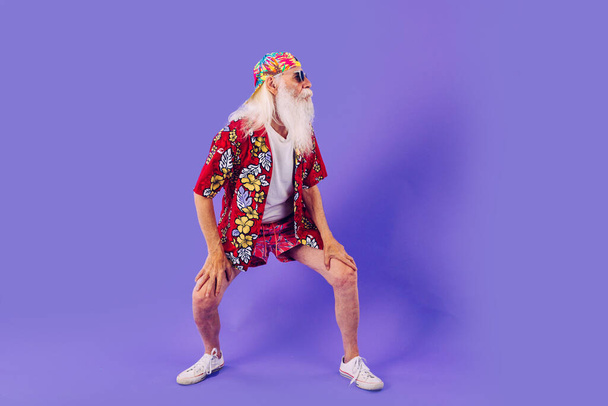 Senior man with eccentric look  - 60 years old man having fun, portrait on colored background, concepts about youthful senior people and lifestyle - Φωτογραφία, εικόνα