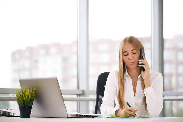blonde talking on the phone, business woman in the office - Photo, Image