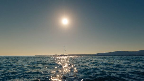 beautiful sailing yacht on the horizon at sunset, beautiful natural landscape, toning effect - Фото, зображення