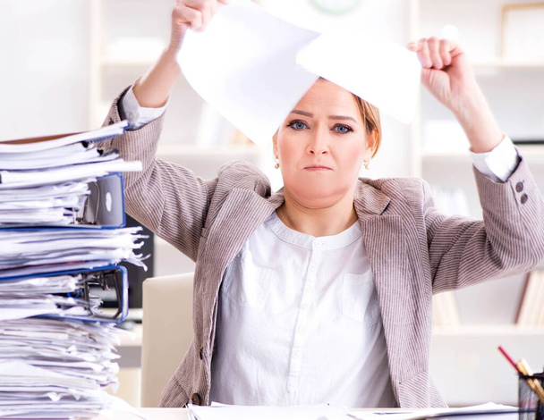 Businesswoman very busy with ongoing paperwork - Photo, Image