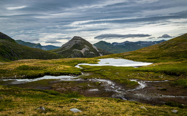 Scottish Highlands landscape. Peak of Binnein Beag seen across the small lochan from the hiking trail in Mamores range, Scotland. - Photo, image