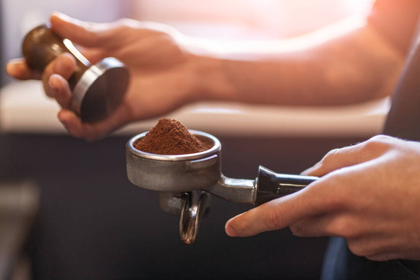 Barista with tamper making coffee - Φωτογραφία, εικόνα