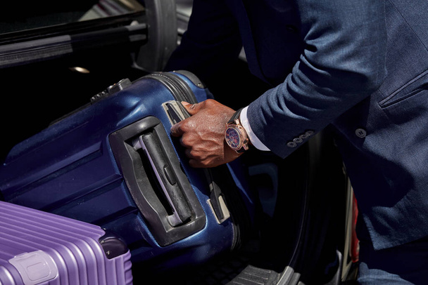 man puts luggage in a car - Photo, image