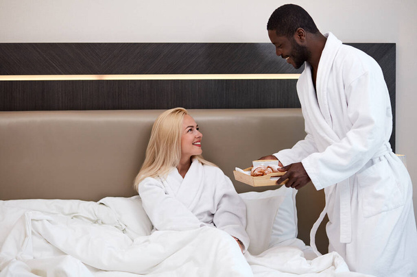 african man treats his wife with breakfast - 写真・画像