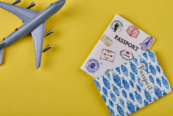 Toy plane and passports. - Φωτογραφία, εικόνα